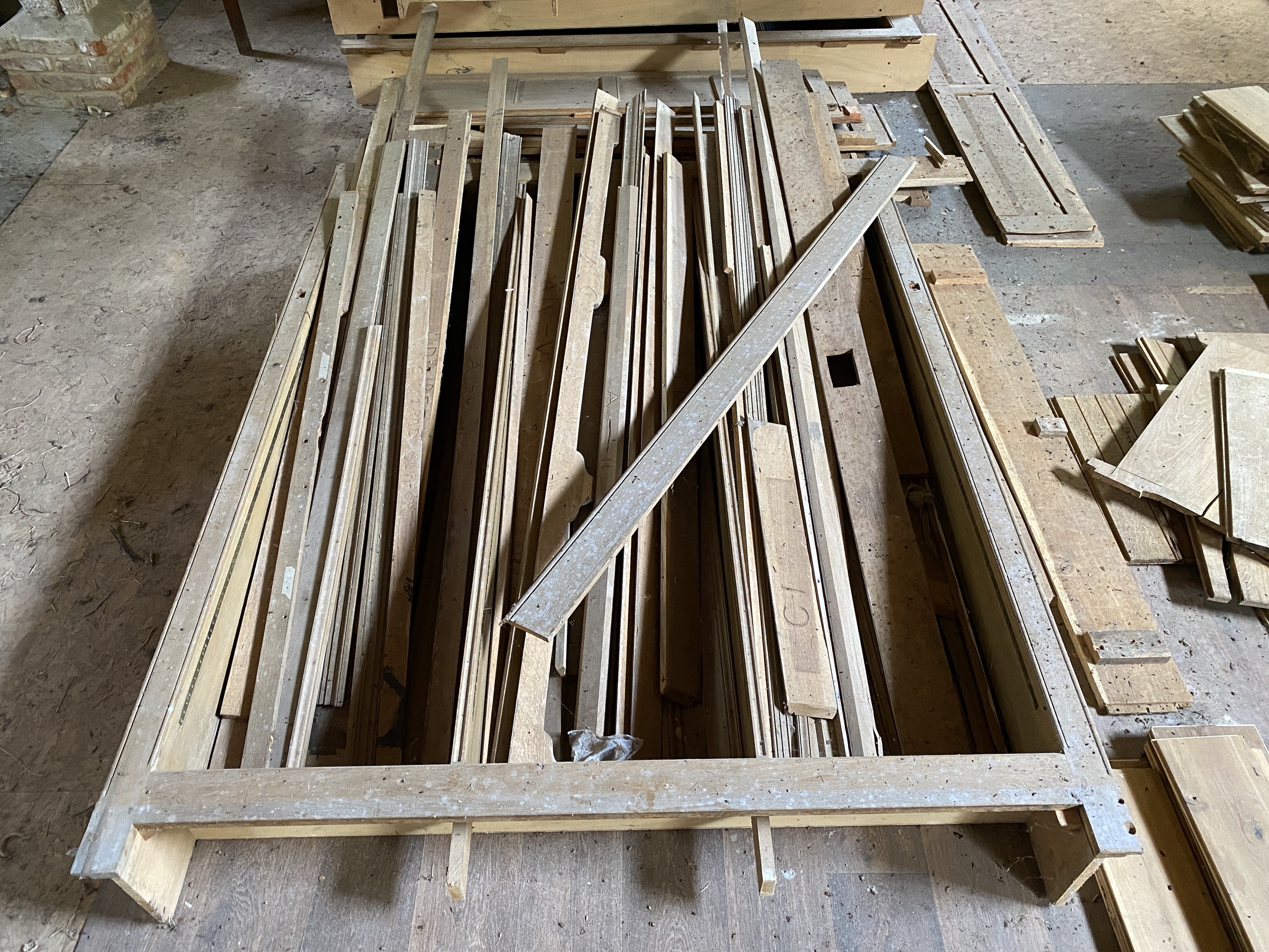 Three dismantled oak bookcases, formerly in the library at Plumpton Place, consisting of an ‘’L’’ shaped section, 455cm, the return 124cm; another ‘’L’’ section, 110cm, the return 68cm, and single section, 255cm, Overall